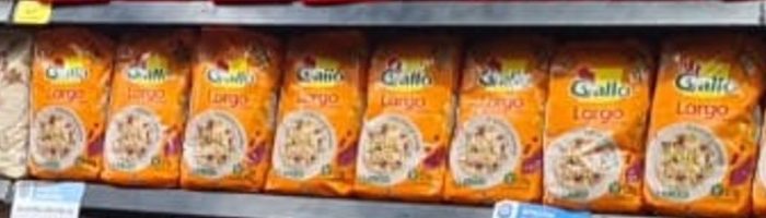 Eight orange Gallo Largo rice bags in a row, with a ninth bag cut off at the right edge