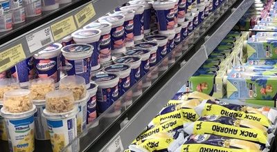 Yogurísimo strawberry yogurt cups in a dairy fridge; the cups in front have no second cup stacked on top